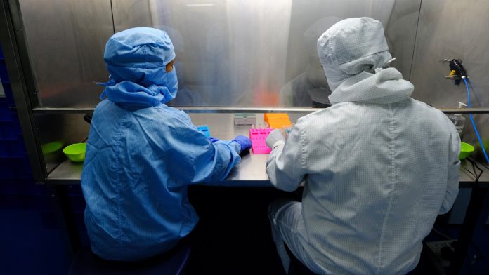 Production of Corosure, The World's Most Affordable Covid-19 Testing kit According to Producer Indian Institute of Technology Lab technicians produce Covid-19 diagnostic kits in a laboratory in Faridabad